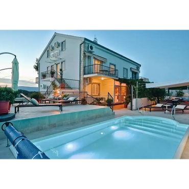 Modern glasfiberpool Aves med avrundad trappa och kaklad omgivning vid villa