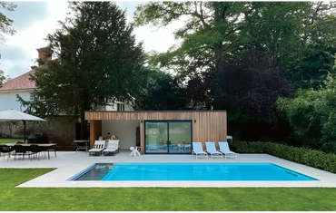Leisurepools Cube medence – modern kialakítás, kültéren, faburkolatú medenceház, nagy üvegajtók
