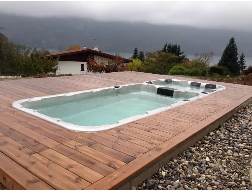 Vit PassionSpa Aquatic 3 Swim Spa – Sport Collection, vit rektangulär med svarta säten och jetstrålar på trädäck